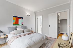 Regina apartment for rent - A bedroom with a large bed and a painting on the wall.