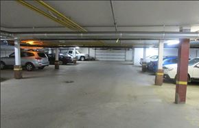 Regina condo for rent - A parking garage with several cars parked.