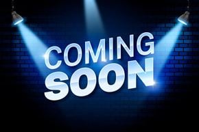Regina condo for rent - A neon sign with the words "COMING SOON" illuminated by spotlights.