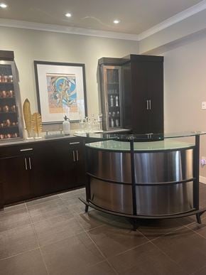 Regina condo for rent - A modern kitchen with a curved glass island and dark wood cabinets.