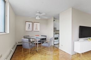 Regina apartment for rent - A dining room with a glass table and chairs.
