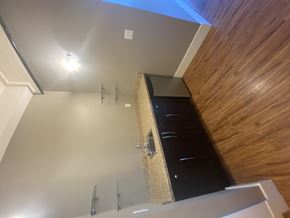 Regina condo for rent - A nook with a wooden wall, cabinets and a dishwasher.