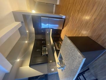 Regina condo for rent - A modern kitchen with a wooden counter and stainless steel appliances.