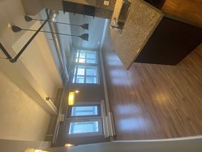 Regina condo for rent - A large island overlooking a well lit living room.