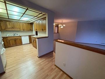 Regina condo for rent - A kitchen with wooden cabinets and a counter top.