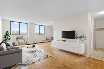 Regina apartment for rent - A living room with a grey couch and a white sofa.