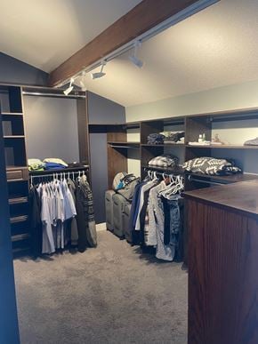Regina condo for rent - A walk in closet with clothes hanging and shelves.