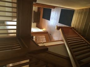 Regina apartment for rent - A wooden staircase leads up to a second floor.