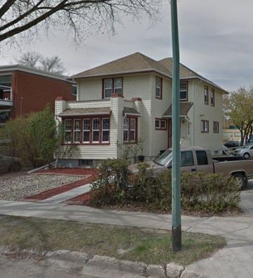 Regina apartment for rent - A house with a red brick building next to it.