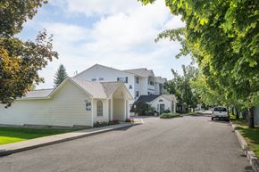 Spokane Valley apartment for rent - a street with white houses and a car parked on the side of the road