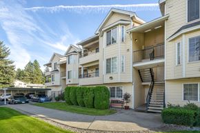 Spokane apartment for rent - the view of an apartment building with balconies and cars parked in front of it