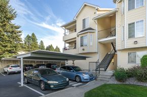 Spokane apartment for rent - an apartment building with cars parked in front of it