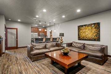 Spokane apartment for rent - A living room with a brown couch and a painting on the wall.