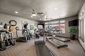 Spokane apartment for rent - A gym with treadmills, elliptical machines, and other exercise equipment.