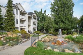 Spokane apartment for rent - a fountain sits in the middle of a stream in front of a building