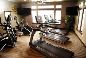 Spokane apartment for rent - a gym with treadmills and televisions
