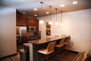 Spokane apartment for rent - a kitchen with a bar and a stainless steel refrigerator