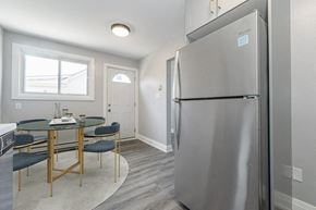 Galt East apartment for rent - a kitchen and dining room with a stainless steel refrigerator and table