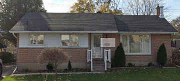 Kingston apartment for rent - a brick house with a sign in the window