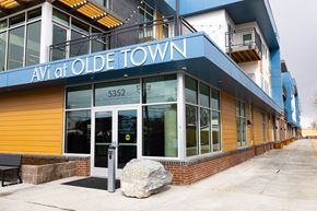 Arvada apartment for rent - Olde Town Avi is a building with a blue and yellow exterior.