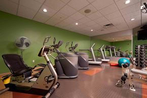 Minneapolis apartment for rent - A gym with a green wall and a variety of exercise equipment.