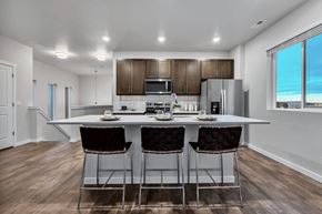 Colorado Springs apartment for rent - A modern kitchen with a dining table and chairs.