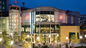 Stamford apartment for rent - A H&M store is lit up at night.