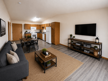 Fargo apartment for rent - A living room with a grey couch and a wooden coffee table.