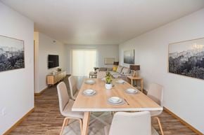 Fargo apartment for rent - A dining room with a long table set for six people.