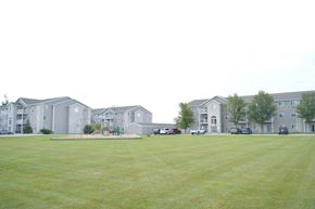 Fargo apartment for rent - Apartment complex with a green lawn in front.