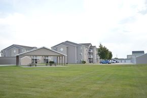 Fargo apartment for rent - A large grassy field in front of apartment buildings.