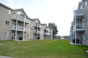 Fargo apartment for rent - Apartment complex with a green lawn in front.