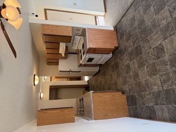 Bismarck apartment for rent - A modern kitchen with wooden cabinets and a white countertop.