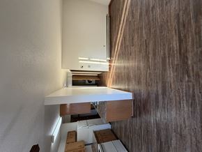 Bismarck apartment for rent - A modern kitchen with a wooden countertop and a white wall.