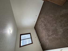 Bismarck apartment for rent - A small window in a room with a brown carpet.