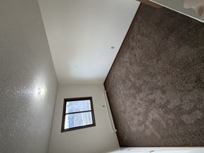 Bismarck apartment for rent - A small window in a white room with a brown carpet.
