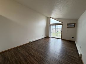 Fargo apartment for rent - A room with wooden flooring and a window.