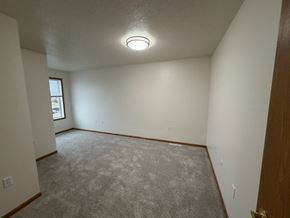 Fargo apartment for rent - A room with a carpeted floor and a window.