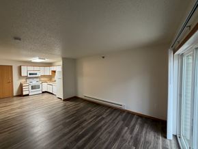 Fargo apartment for rent - A kitchen with white appliances and wooden floors.