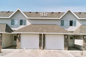 Fargo apartment for rent - A two-story house with a garage on the first floor.