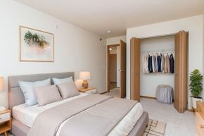 Fargo apartment for rent - A bedroom with a large bed and a wardrobe.