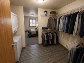 Fargo apartment for rent - A laundry room with a washer and dryer and a bed.