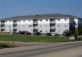 Aberdeen apartment for rent - A large white apartment building with a parking lot in front.
