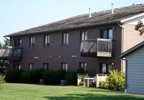 Aberdeen apartment for rent - A brick building with a balcony and a small garden in front.