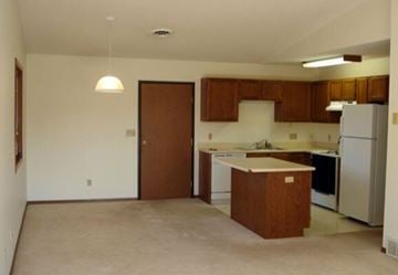 Aberdeen apartment for rent - A kitchen with white appliances and brown cabinets.