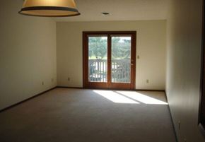 Aberdeen apartment for rent - A room with a brown carpet and a brown door leading outside.