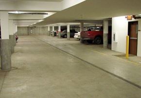 Aberdeen apartment for rent - A parking garage with a red car parked in the middle.