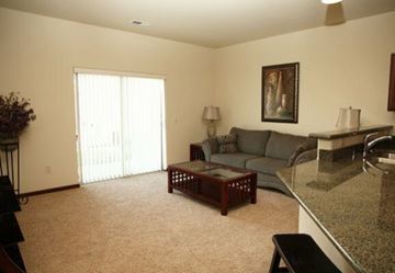 Aberdeen apartment for rent - A living room with a grey couch, a coffee table, and a painting on the wall.