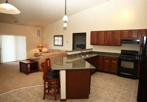 Aberdeen apartment for rent - A kitchen with a black refrigerator and wooden cabinets.