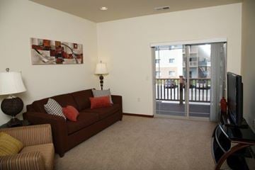 Aberdeen apartment for rent - A living room with a brown couch and a painting on the wall.